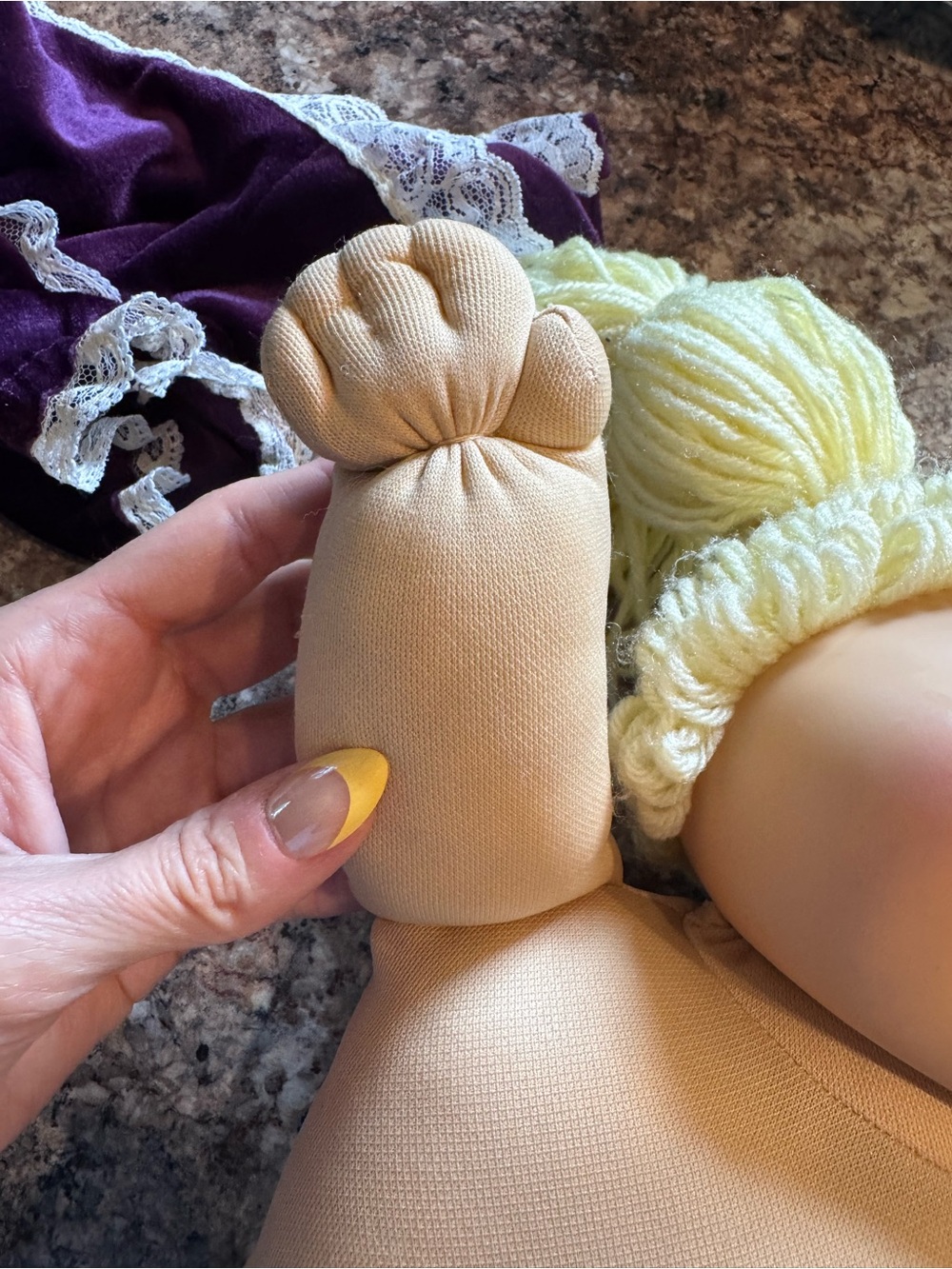 A Cabbage Patch Kid doll with blonde yarn hair and a purple dress - Picture 5 of 11